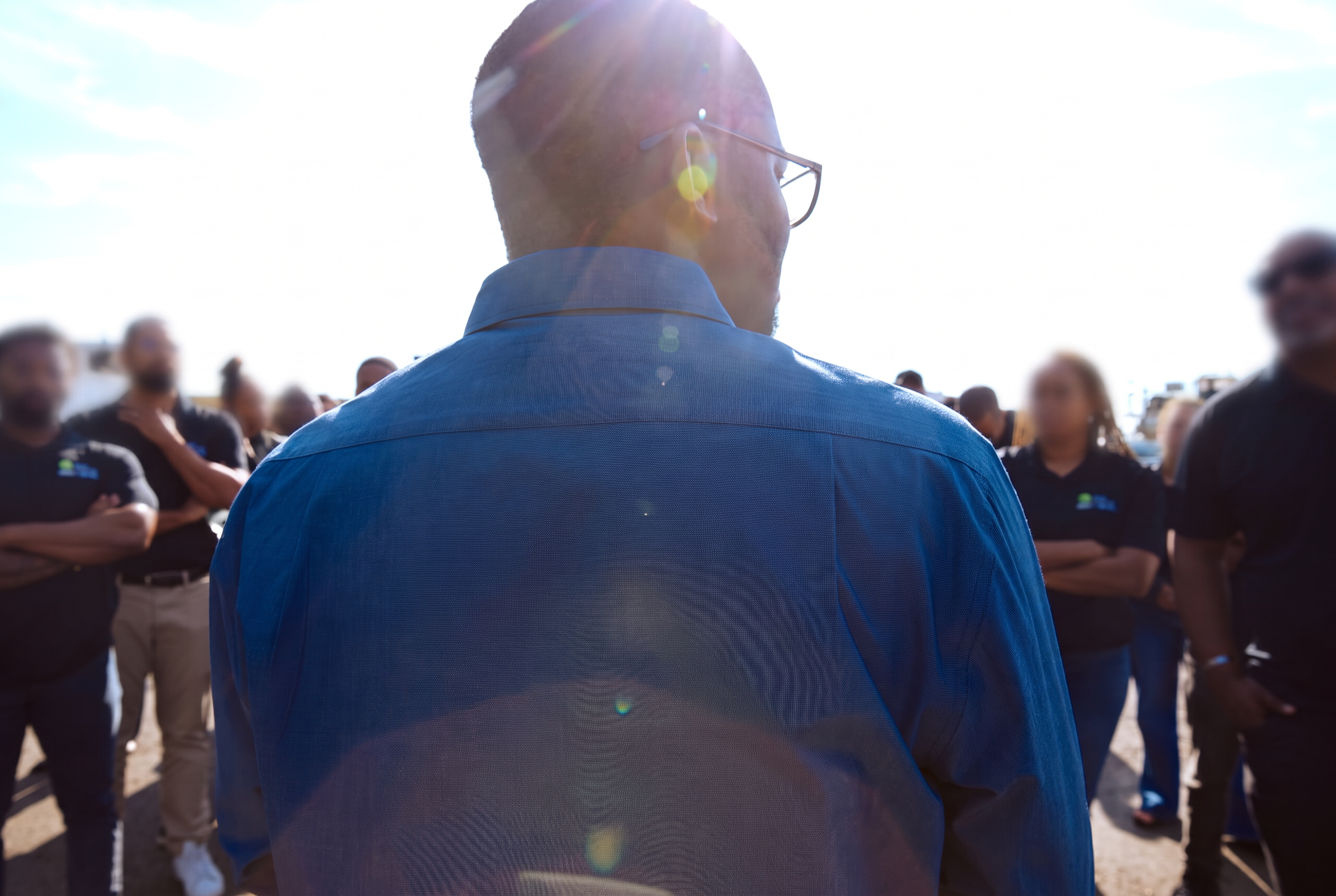 A speaker addressing a crew outdoors.